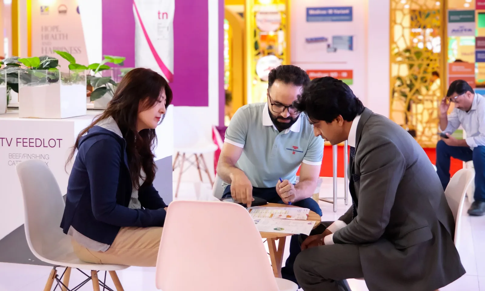 Total Nutrition team consulting with international visitors at an industry exhibition booth